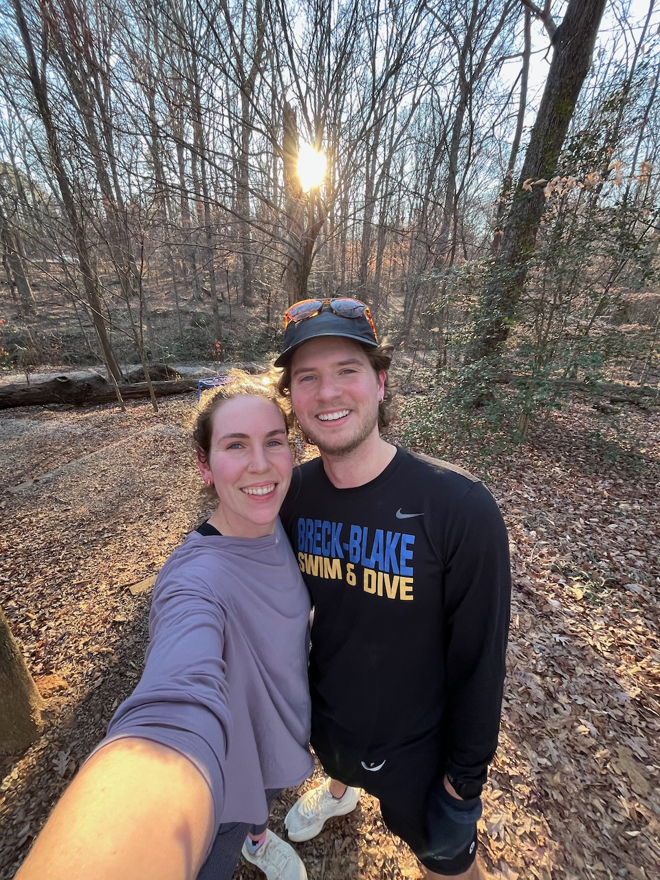Two adults stopping for a selfie on a hike
