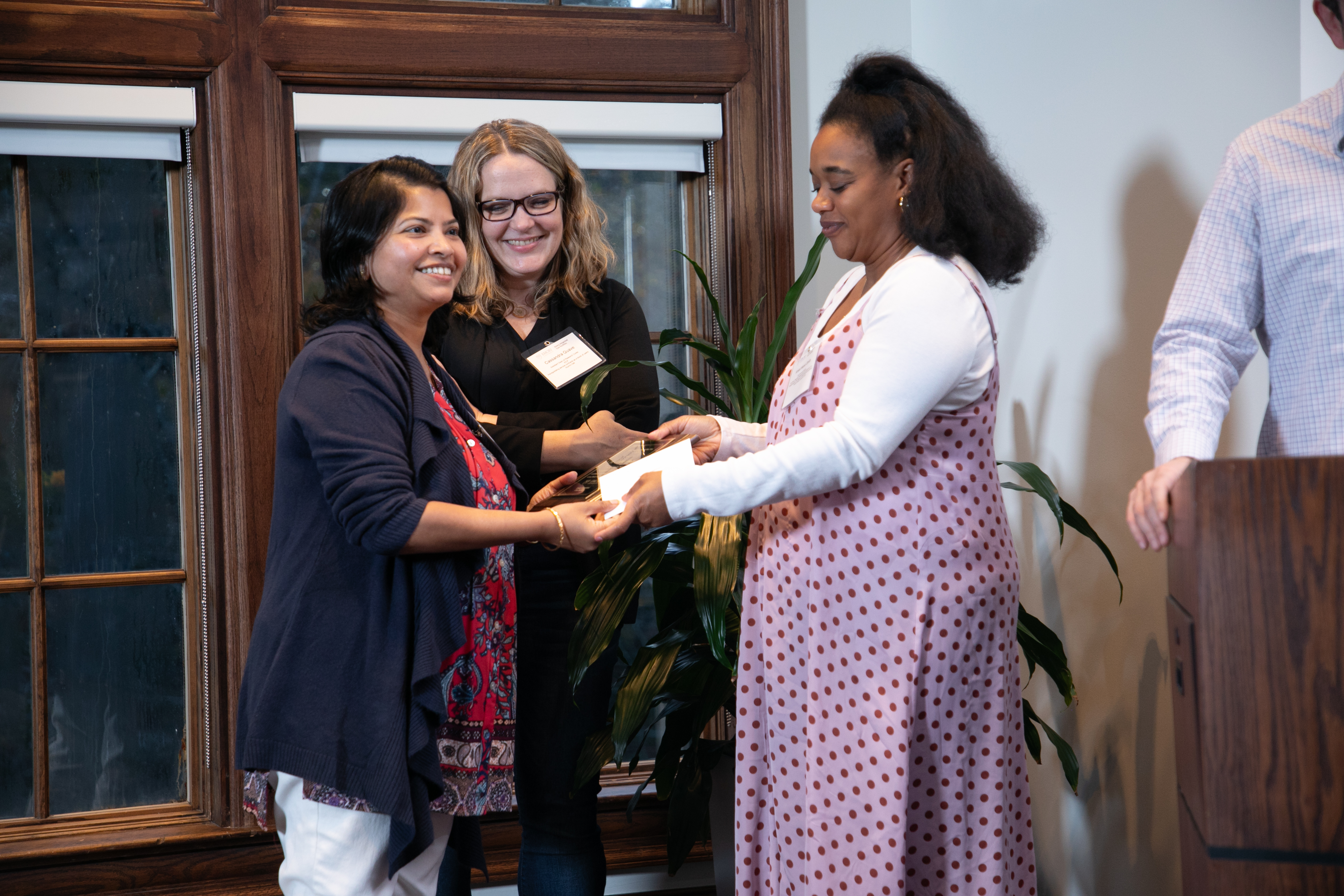 Cassandra Quave and Kristal Maner-Smith, PhD, bestow the Core Staff of the Year award to Pritha Bagchi, PhD. 