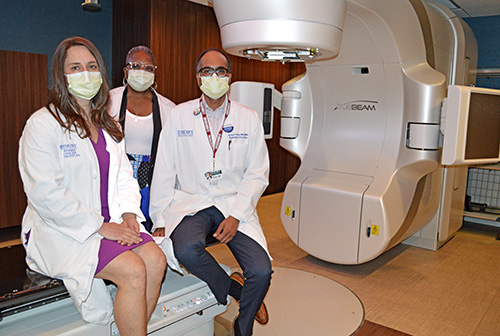 Heather Gatcombe, MD, Tonya Echols Cole, MD, and Ashish B. Patel, MD, in the treatment room with the new linear accelerator.
