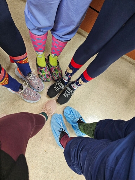 five pairs of legs showing different colored and patterned socks